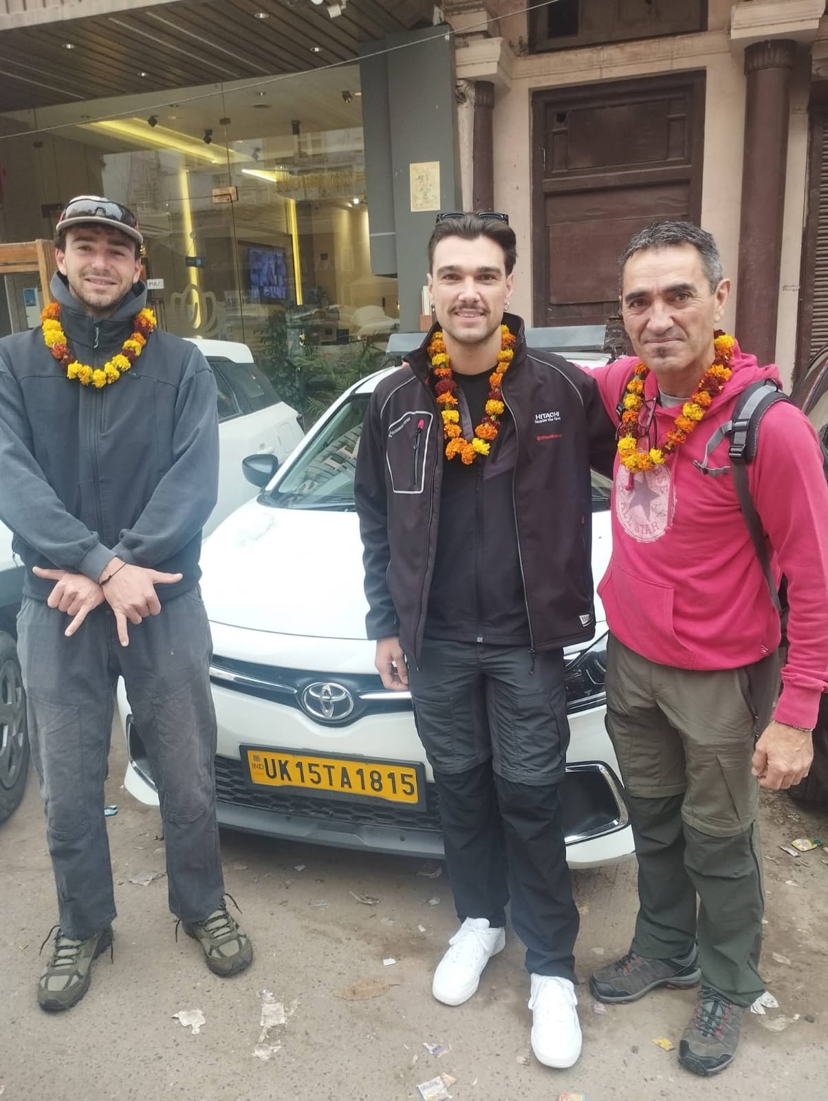 Travellers welcomed beside their taxi